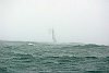 Bernard Stamm on Bobst Group-Armor lux appears through the mist and rain to win leg 3 of the Around Alone into Tauranga, New Zealand.<br>