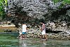 The Kingdom Of Tonga in the South Pacfic <br>Kids from the local village walk around the rocks to fish