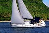 The Kingdom Of Tonga in the South Pacfic <br>Vava'u - A Sunsail charter yacht powers through the water in a warm tropical breeze