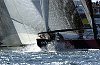 Alinghi crew feed the spinnaker back down the hatch as they try to hold off Oracle.