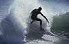 A surfer shreds through the powerful waves of the Pacific
