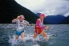2 compeditors of a multisport event stuggle through ice cold water in the South Island of New Zealand