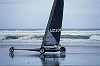 NZ301 winner of the world land yachting champs, speeds along the beach at 120kph