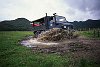 An ex army Unimog ploughs through a huge mud puddle on Great Barrier Island/ New Zealand