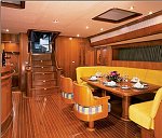 Inside the salon of Happy Jos with the dinning table fully made up.<br>A great example of a well crafted super yacht.